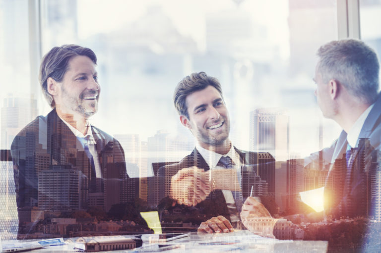 Montage of a team of business people working  at the boardroom table.
