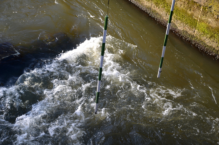 Racing slalom goals for canoe and raft, kayak. Racing track with suspended striped bars on a wild and calm river. both beginner and advanced paddler ride