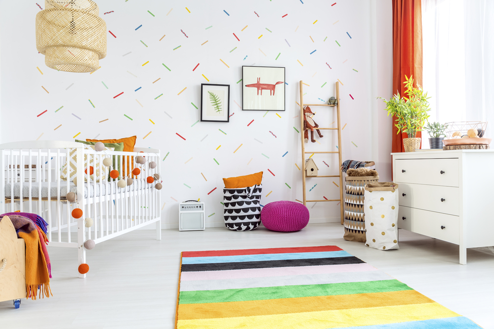 White,Baby,Room,With,Cot,And,Colorful,Rug