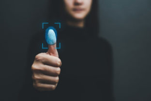 Touch screen, fingerprint scanner, biometric identity of a woman's hand in a blurred background .