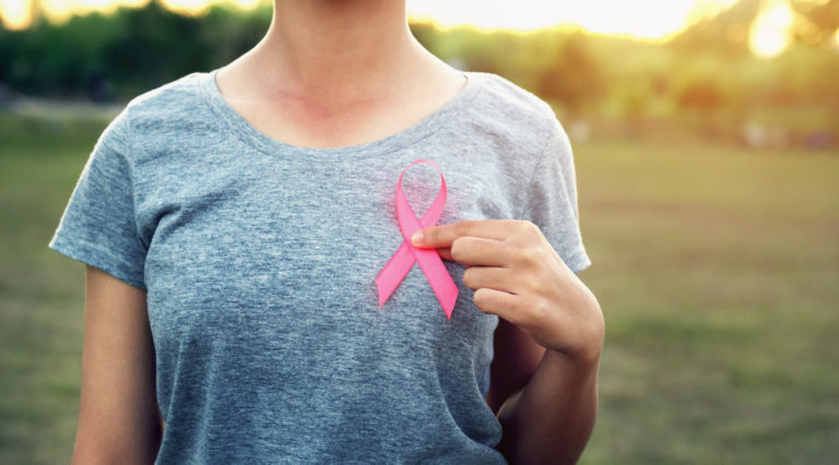 Woman holding pink ribbon breast cancer awareness. concept healthcare
