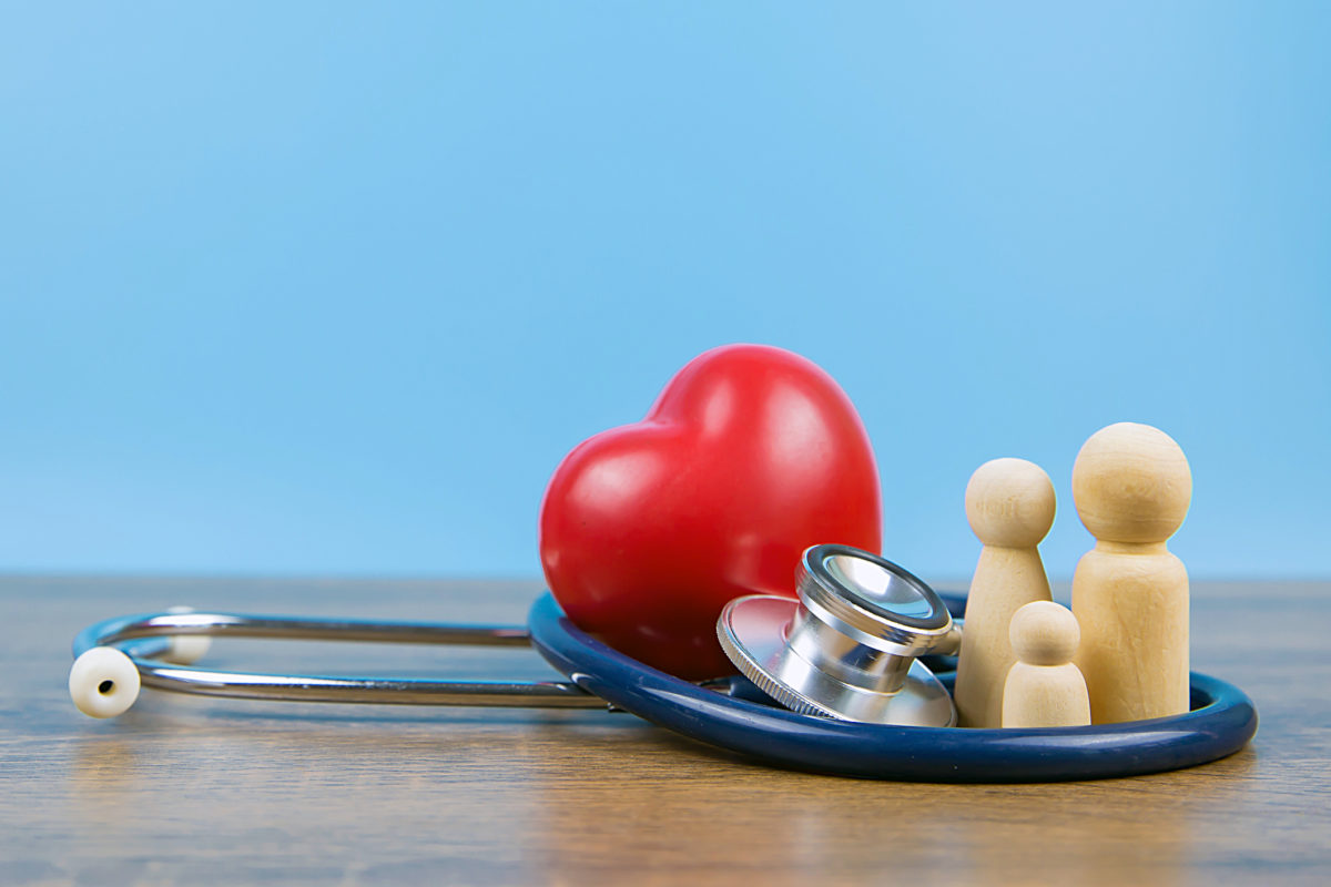 Family with stethoscope and a red heart. Concepts of a physical examination and health insurance.