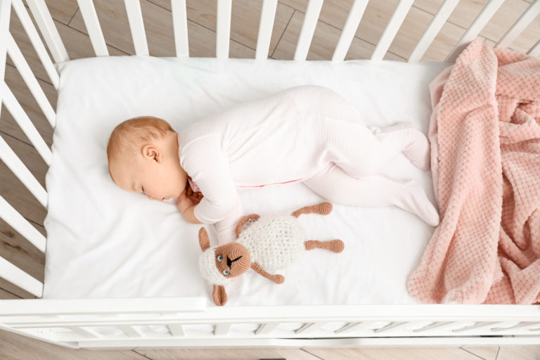Cute sleeping little baby in bed