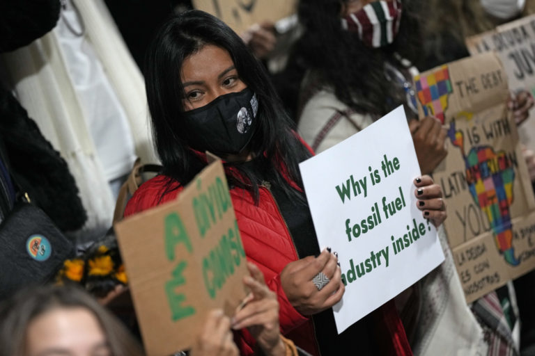 FILE - Youth climate activists protest that representatives of the fossil fuel industry have been allowed inside the venue during the COP26 U.N. Climate Summit in Glasgow, Scotland, Thursday, Nov. 11, 2021.