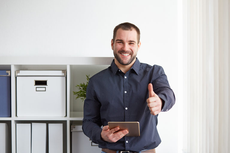 Happy businessman with digital tablet