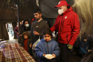 Migration Belarus Poland Migrants receive food inside a Red Cross tent near a logistics center at the checkpoint "Kuznitsa" at the Belarus Poland border near Grodno, Belarus, Sunday, Nov. 21, 2021. The EU says the new surge of migrants on its eastern borders has been orchestrated by the leader of Belarus, President Alexander Lukashenko, in retaliation for EU sanctions placed on Belarus after a government crackdown on peaceful democracy protesters. It calls the move "a hybrid attack'' on the bloc. Belarus denies the charge.