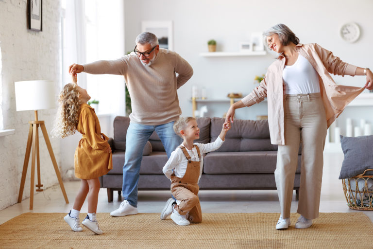 Active,Senior,Grandparents,Dancing,With,Two,Happy,Kids,Grandchildren,In