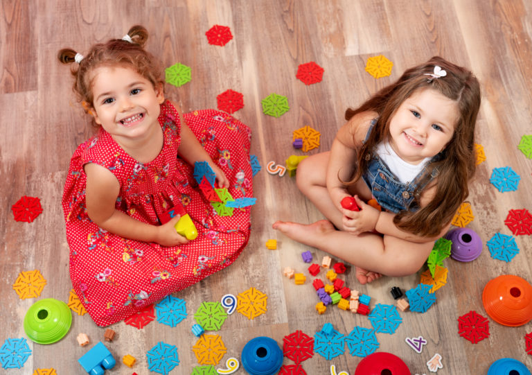 Little girl playing with block toys. Toys for kids.