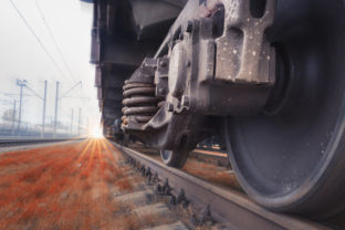 Bottom View of the wheels of a train traveling fast by rail. Fast cargo delivery by train. Blurred background gives a motion effect.