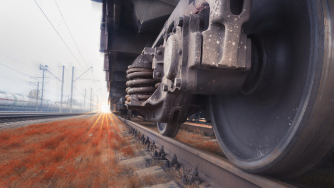 Bottom View of the wheels of a train traveling fast by rail. Fast cargo delivery by train. Blurred background gives a motion effect.