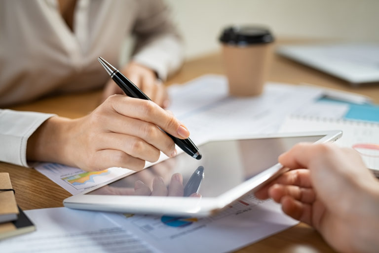 Woman signing contract on digital tablet