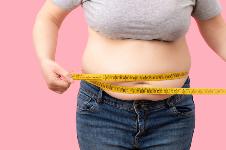 Fat girl with overweight checking out his weight
