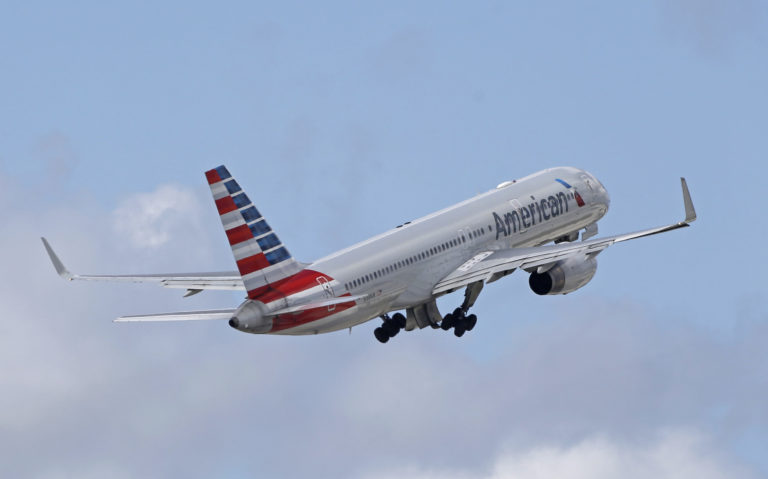 American Airlines In this June 3, 2016 file photo, an American Airlines passenger jet takes off from Miami International Airport in Miami. American Airlines says a passenger entered the open cockpit of a jet that was preparing to take off in Honduras, and he damaged the plane before crew members and police could stop him. American said Wednesday, Jan. 12, 2022 that the man was arrested. The flight, which was bound for Miami, was delayed several hours until American could fly a replacement plane into Honduras.