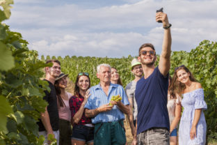 Man takes a selfie during course in vineyard