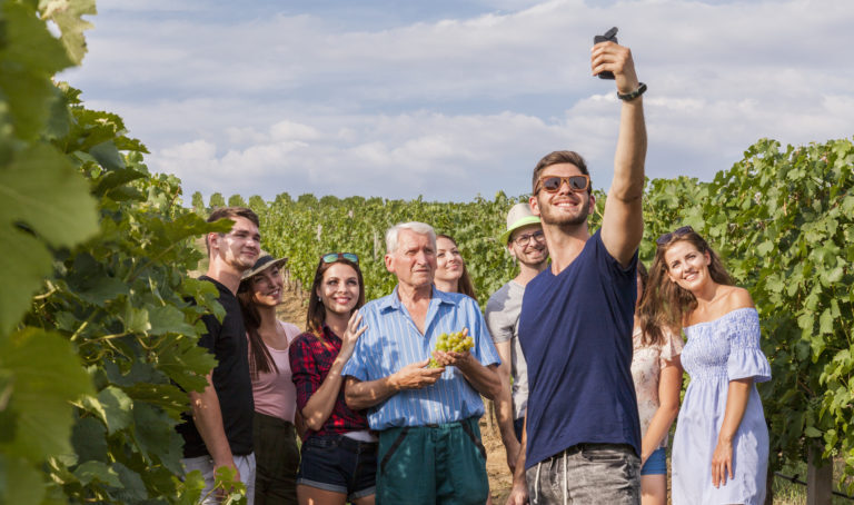 Man takes a selfie during course in vineyard