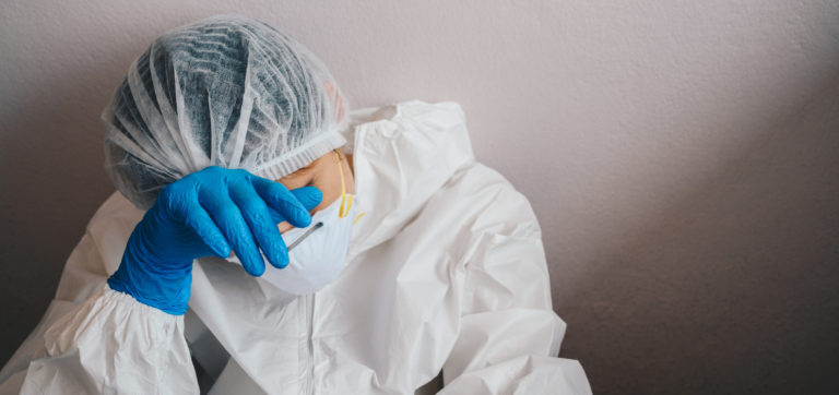 Portrait of sadness healthcare worker woman crying after failure and tired from work because impact from covid 19 pandemic outbreak.