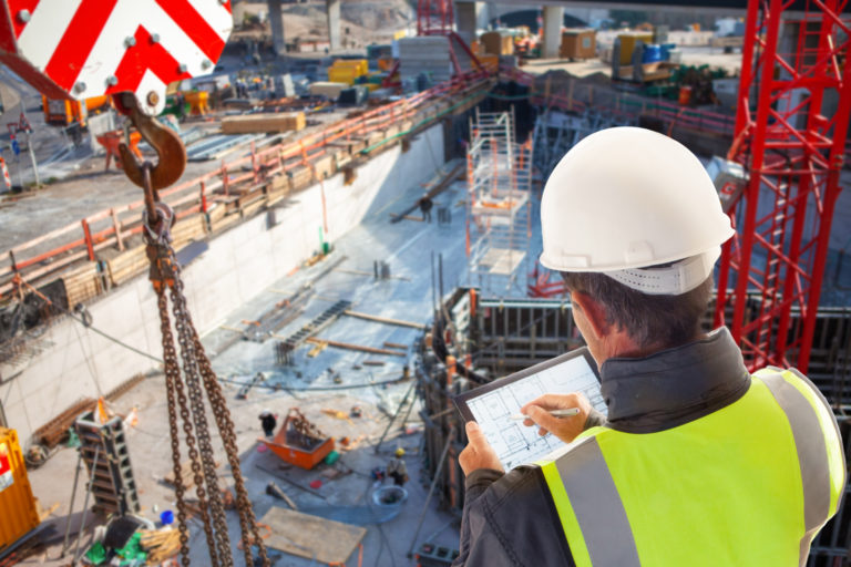 Engineer architect construction worker on construction site with tablet computer