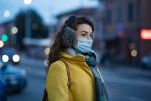 Winter woman wearing mask in city street