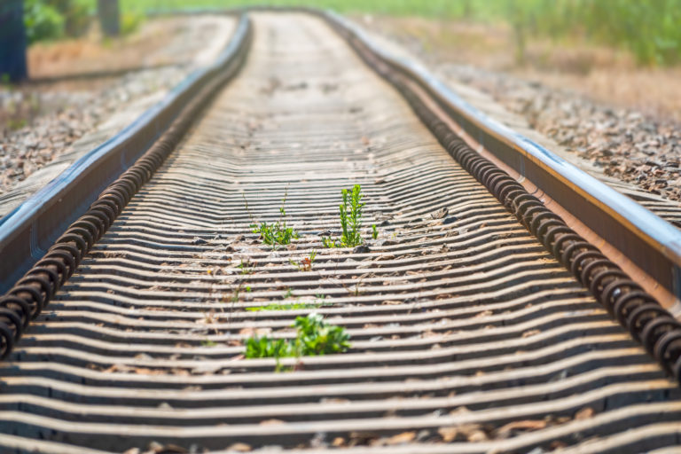 Railway rails going into the distance. Railway rails and sleepers close up.