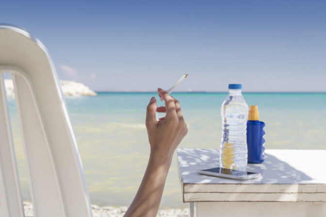 Woman smoking at the beach