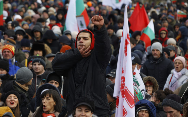 Virus Outbreak Bulgaria A man whistles as he joins a protest in front of the Bulgarian Parliament building in Sofia, Wednesday, Jan 12, 2022. Protesters opposing COVID 19 restrictions in Bulgaria have clashed with police as they were trying to storm the Parliament in Sofia. Heavy police presence prevented protesters from entering the building and some were detained.