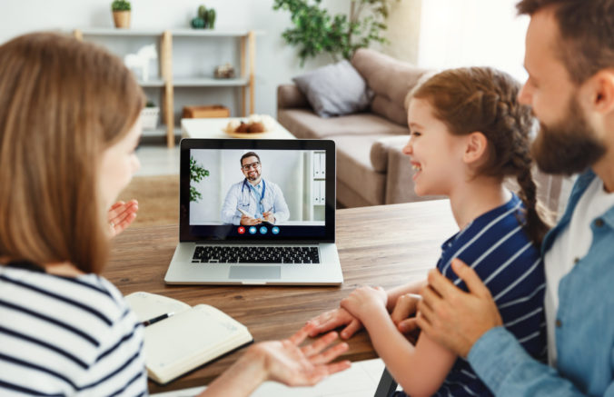 Happy family making video call to doctor