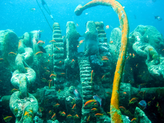 Old chain lifting mechanism anchors on a sunken ship.