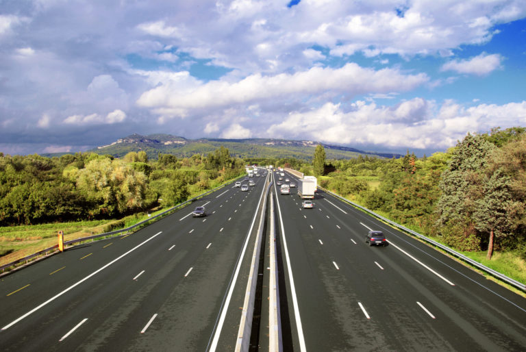 Aerial view of a highway under a cloudy sky.