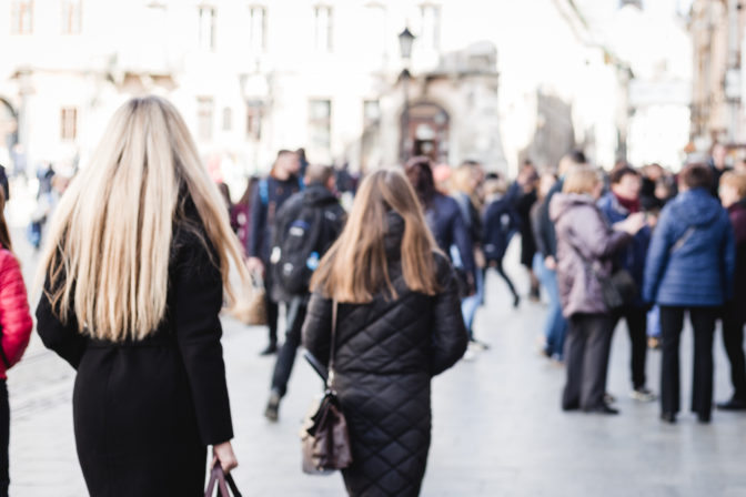 Blurred background. Blurred people walking through a city street. Crowd