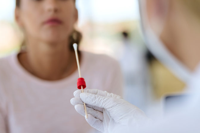 Close up of healthcare worker taking PCR test at medical clinic.