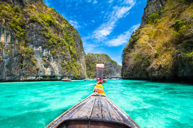 A wooden boat sailing near phi island in Thailand