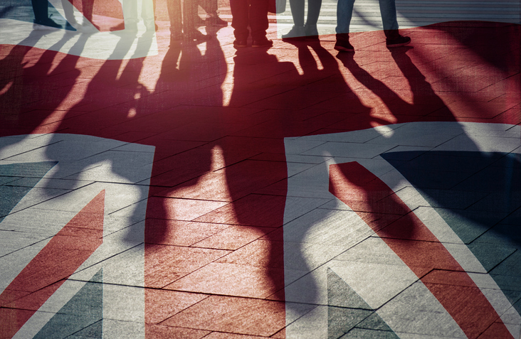 UK flag and UK flag and shadows of people - concept picture shadows of people - concept picture