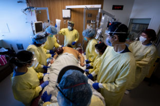 Virus Outbreak Canada Respiratory therapist Mehul Delvada, back centre, and health care workers prone a ventilated COVID 19 patient who's also an unvaccinated nurse in the intensive care unit at the Humber River Hospital during the COVID 19 pandemic in Toronto