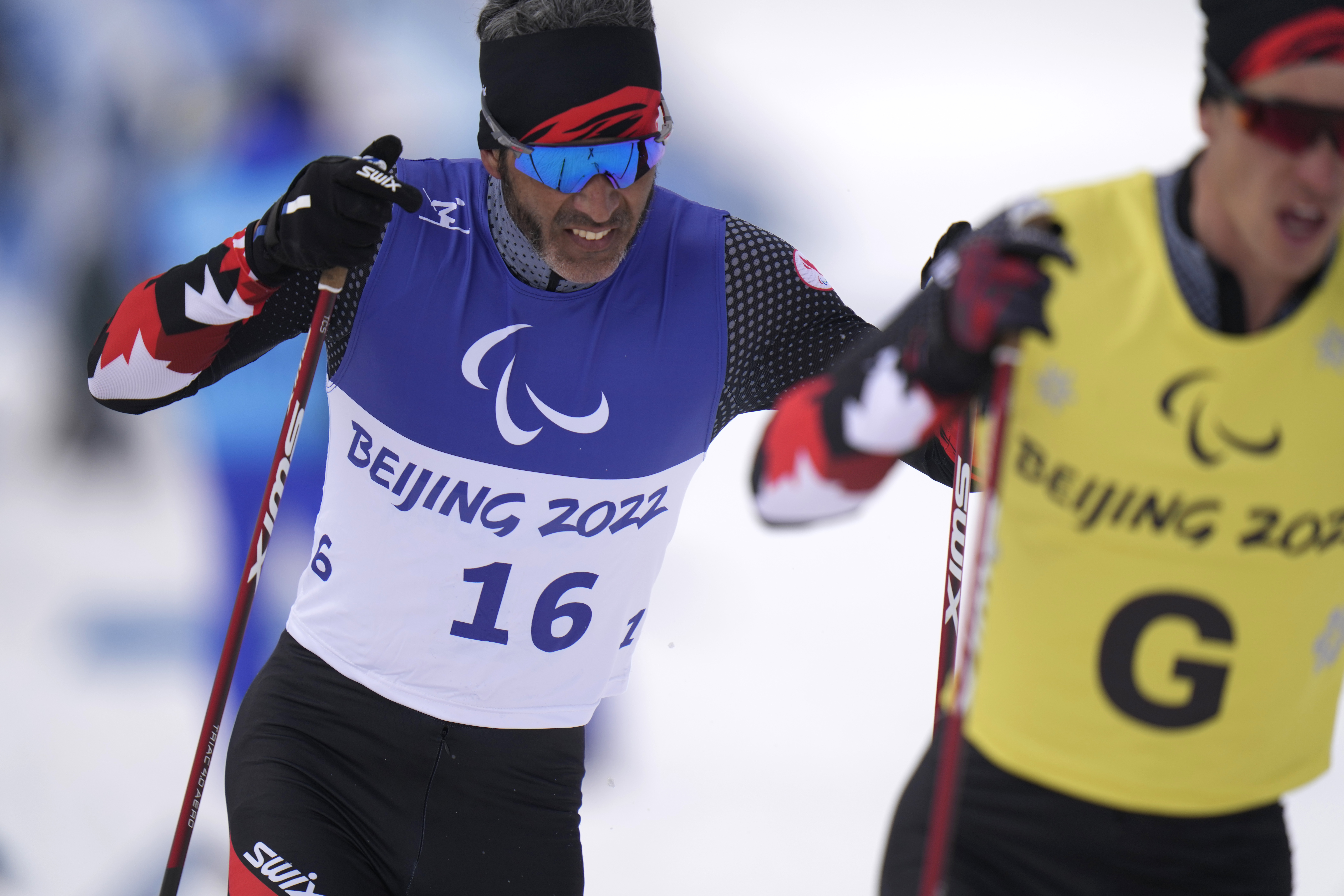Canada's Brian McKeever and his guide Graham Nishikawa compete during the men's middle distance free technique vision impaired event of para cross country skiing at the 2022 Winter Paralympics, Saturday, March 12, 2022, in Zhangjiakou, China