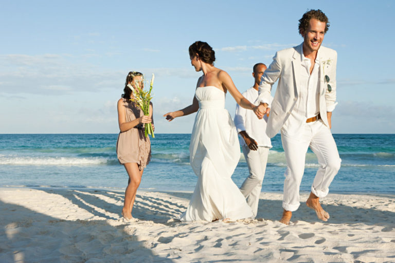 Married couple on beach with friends