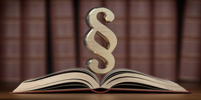 Paragraph sign on the open book. Searching, justice and law concept.