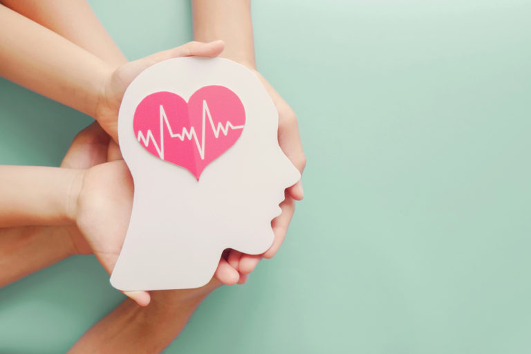 Adult and children hands holding paper brain and heart, brain stroke, world heart day, world mental health day, Alzheimer and wellness concept