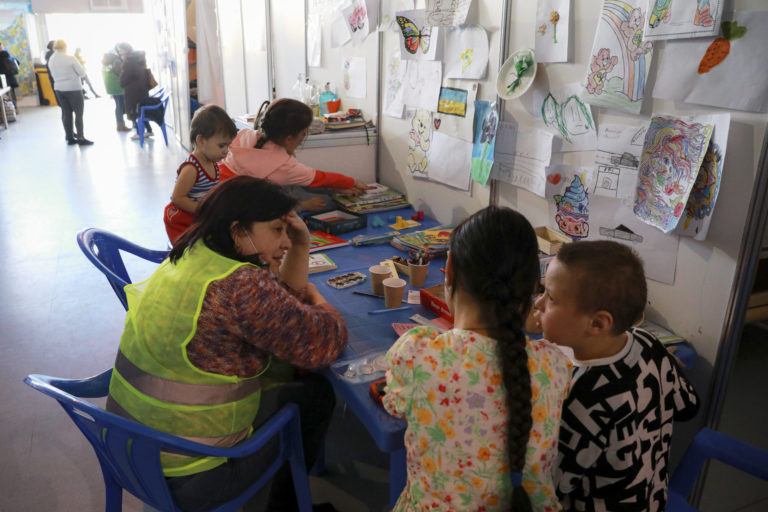 Moldova Russia A volunteer talks to children that fled the war in Ukraine with their families, in a refugee center, in Chisinau, Moldova Ukraine War