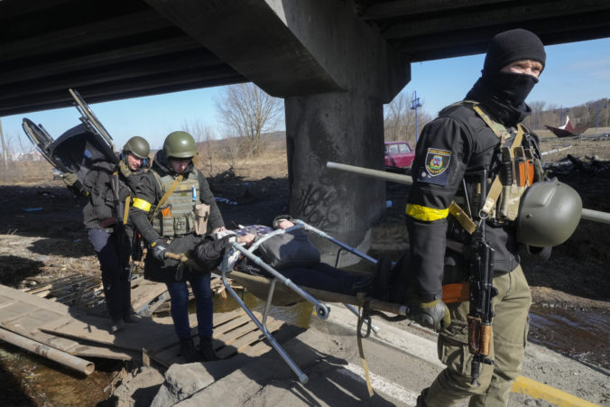 Russia Ukraine War Day In Photos Ukrainians soldiers pass an improvised path under a destroyed bridge as they evacuate an elderly resident in Irpin, northwest of Kyiv