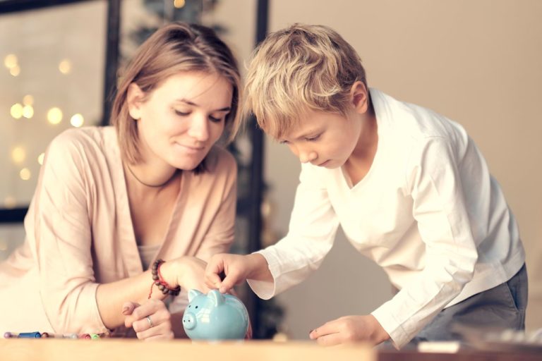 Mother,And,Child,Putting,Coin,Into,Piggy,Bank.,Education,Of