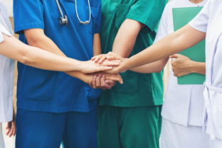 Cooperation of people in the medical community teamwork with a hands together