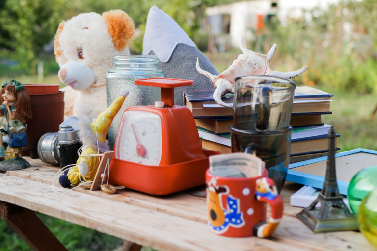 Garage sale outdoor. Old stuff on the table in the yard Secondhand concept