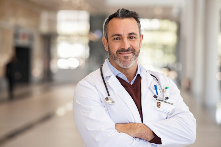 Confident successful mature doctor at hospital