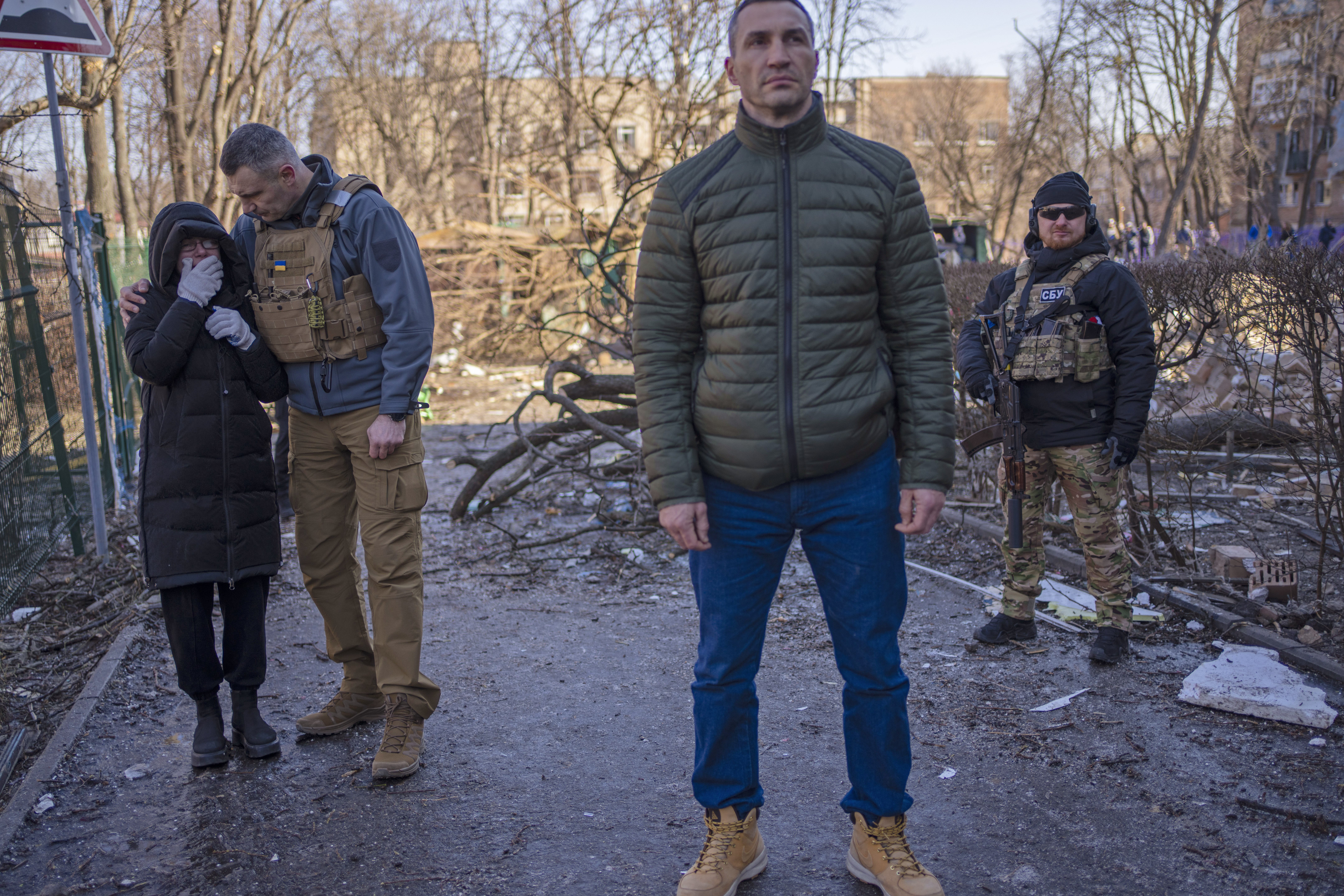 Russia Ukraine War Kievs's Mayor, Vitali Klitschko, left, conforts a neighbor who cries at the site where a bombing damaged residential buildings in Kyiv, Ukraine, Friday, March 18, 2022. Russian forces pressed their assault on Ukrainian cities Friday, with new missile strikes and shelling on the edges of the capital Kyiv and the western city of Lviv, as world leaders pushed for an investigation of the Kremlin's repeated attacks on civilian targets, including schools, hospitals and residential areas