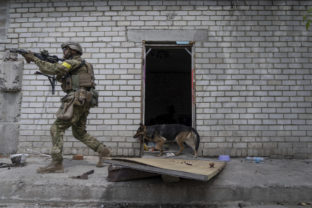 A Ukrainian serviceman patrols during a reconnaissance mission in a recently retaken village on the outskirts of Kharkiv, east Ukraine, Saturday, May 14, 2022. ()