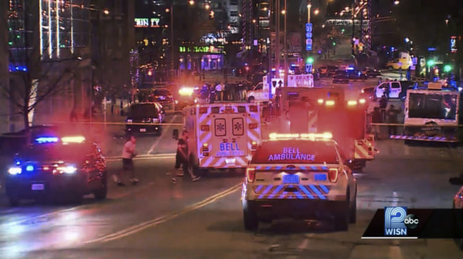 This photo taken from video provided by WISN 12 News shows police responding to the scene of a shooting at Water Street and Juneau Avenue in Milwaukee, Friday, May 13, 2022. Twenty people were injured in two shootings in downtown Milwaukee near an entertainment district where thousands of people were watching the Bucks play the Celtics in the NBA's Eastern Conference semifinals, authorities said. There was no immediate indication whether the two shootings were related or involved fans who were watching the game. ()
