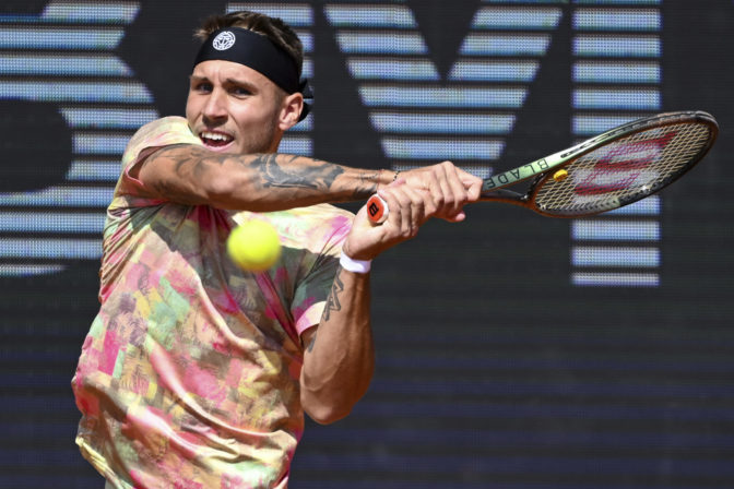 Alex Molcan of Slovakia returns the ball to Casper Ruud of Norway at the ATP tennis tournament in Munich, Germany