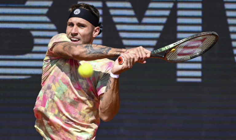 Alex Molcan of Slovakia returns the ball to Casper Ruud of Norway at the ATP tennis tournament in Munich, Germany
