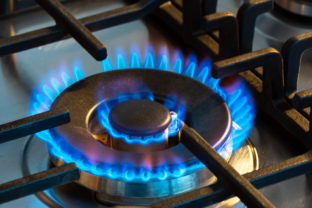 Gas burning with blue flames on the burner of a gas stove