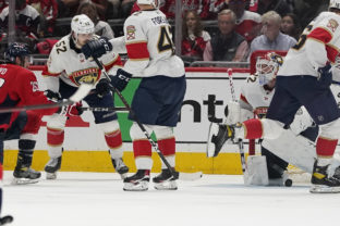 Washington Capitals center Nic Dowd, left, shoots the puck under Florida Panthers goaltender Sergei Bobrovsky (72) for a goal during the second period of Game 6 in an NHL hockey Stanley Cup playoffs first-round series Friday, May 13, 2022, in Washington. ()
